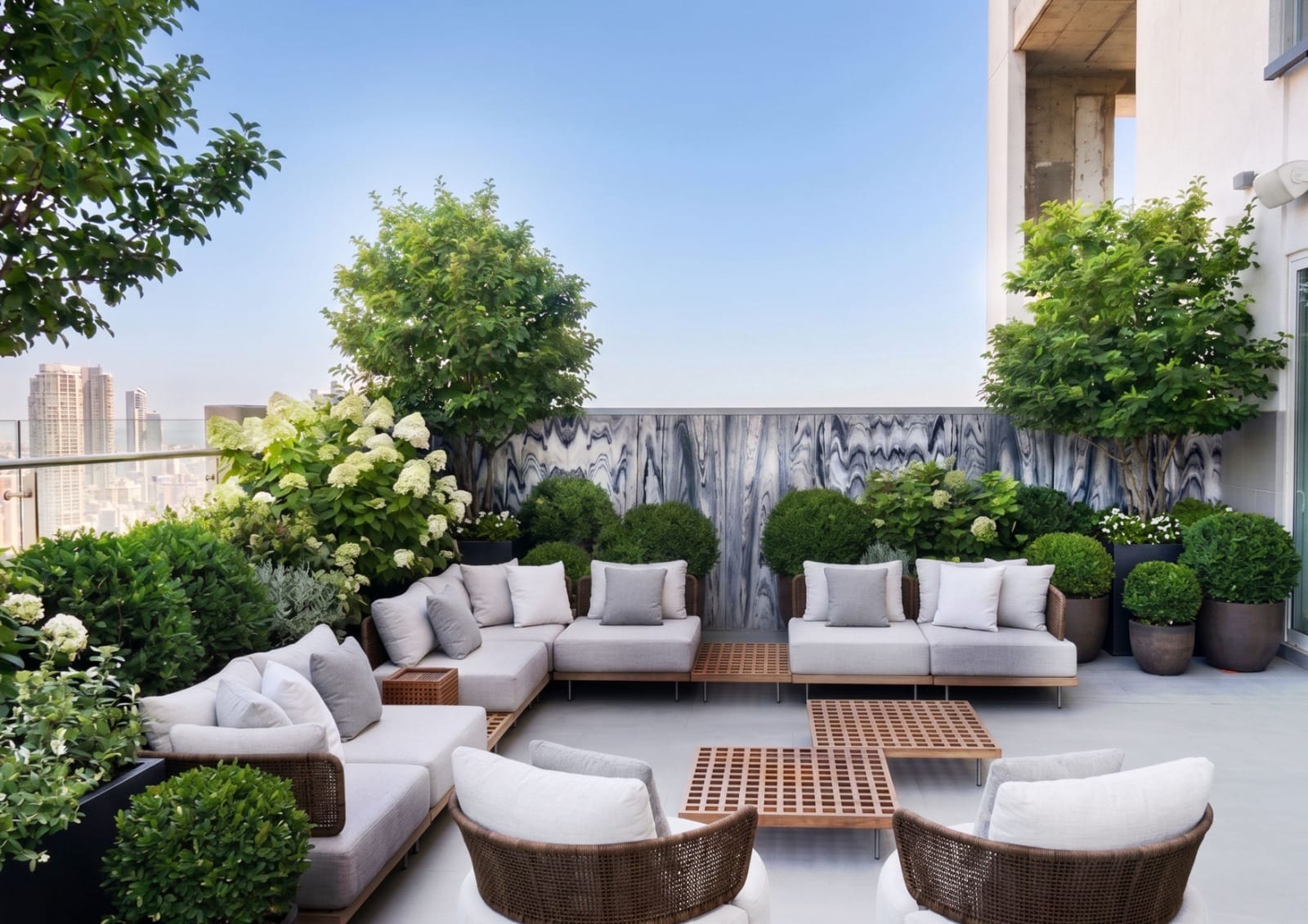 Curated potted greenery on a rooftop lounge terrace with skyline view